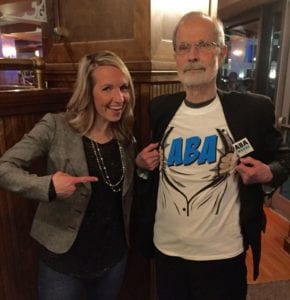 Breanne presenting her mentor, Dr. Maloff, with an ABA superhero shirt.