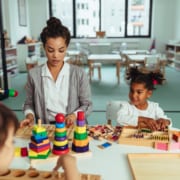 Teacher and children being creative with colorful toys